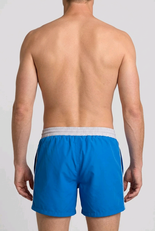 Man wearing blue swim shorts back view