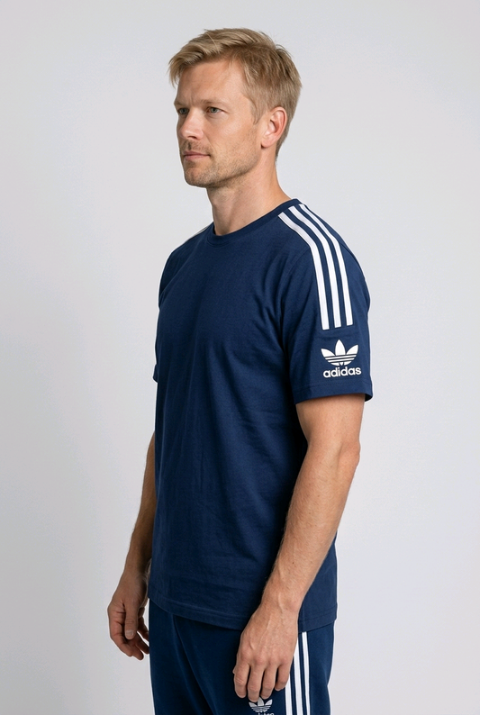 Side view of a man wearing an Adidas t shirt