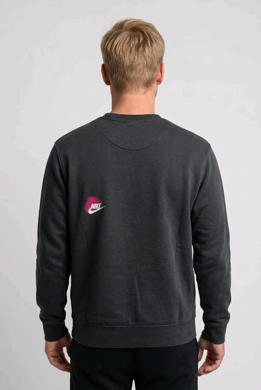 Man wearing a grey Nike sweatshirt back view