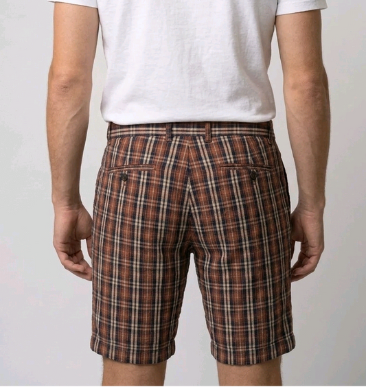 Man wearing a white t-shirt and plaid shorts