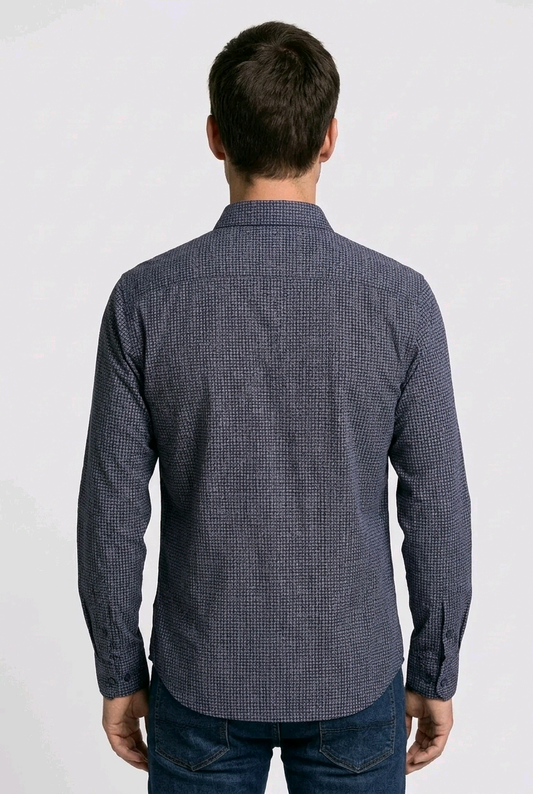 Man wearing a blue patterned shirt on a white background