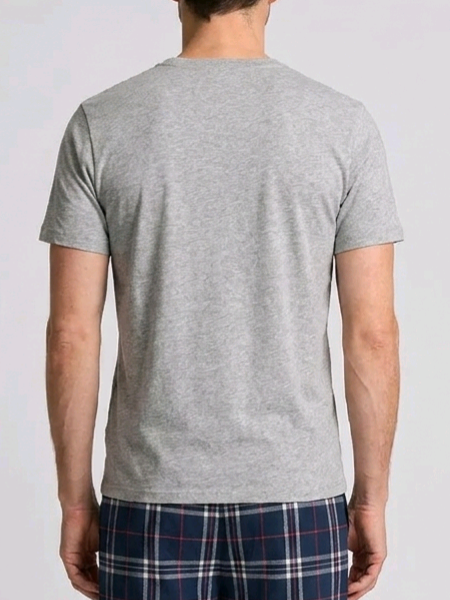 Person wearing a grey t-shirt and plaid pants
