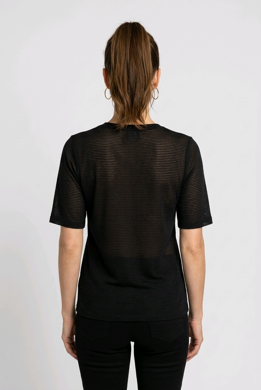Woman wearing a Nike black textured shirt from behind