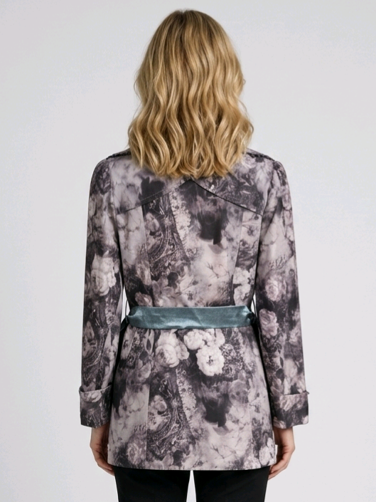 Woman wearing a patterned coat with a belt