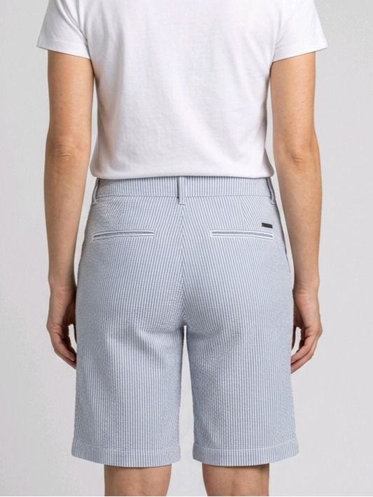Woman wearing navy and white pinstripe shorts and a white t-shirt