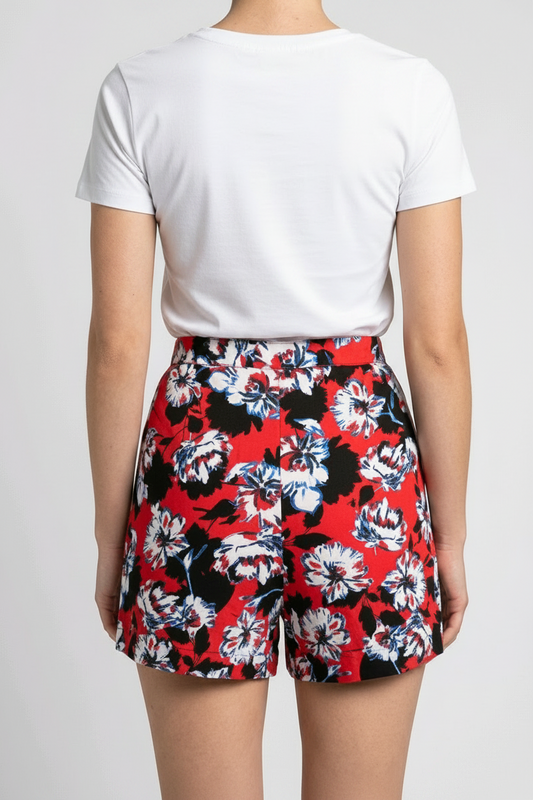Woman wearing a white t-shirt and red floral shorts