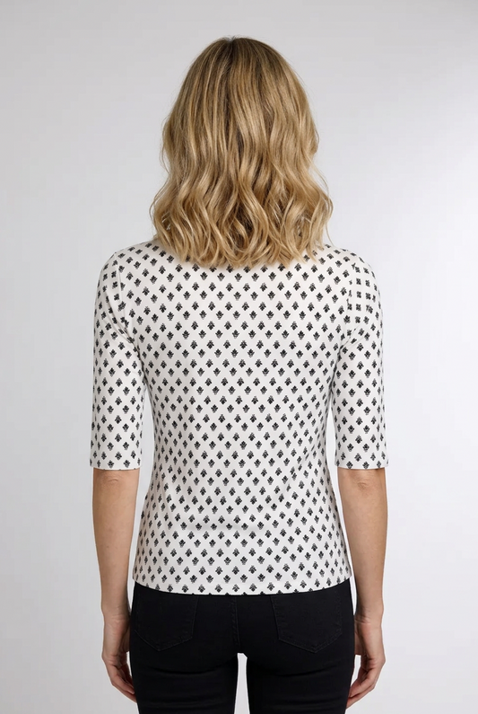 Woman wearing a black and white patterned top