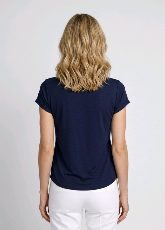 Person wearing a navy blue t-shirt and white pants
