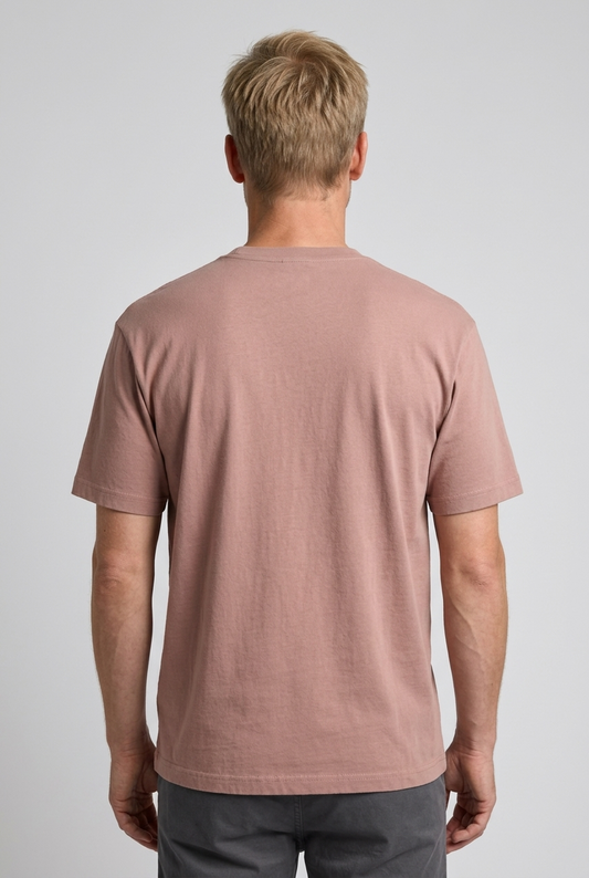 Man wearing a dusty rose t-shirt on a plain background