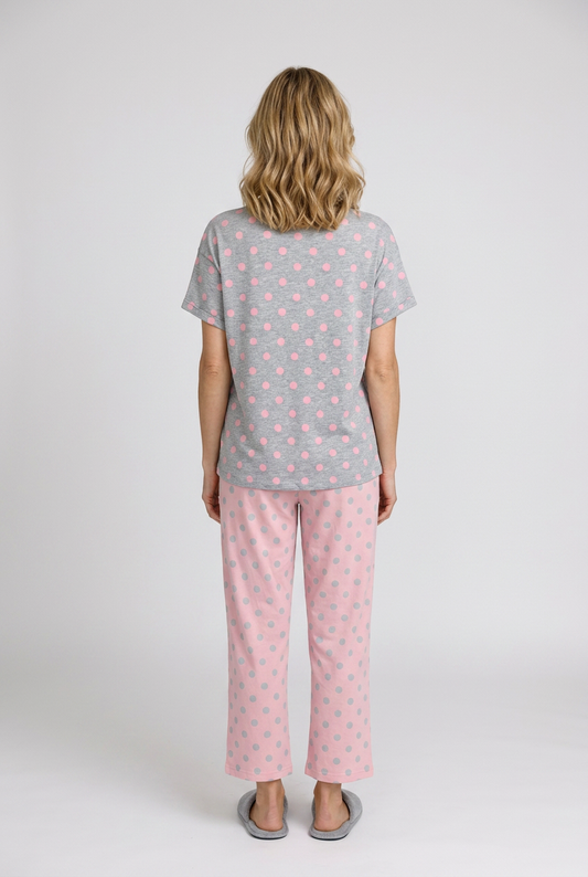 Woman wearing a grey t-shirt pink pyjama set