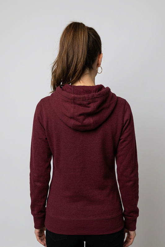 Woman wearing a maroon hoodie from behind on a plain background