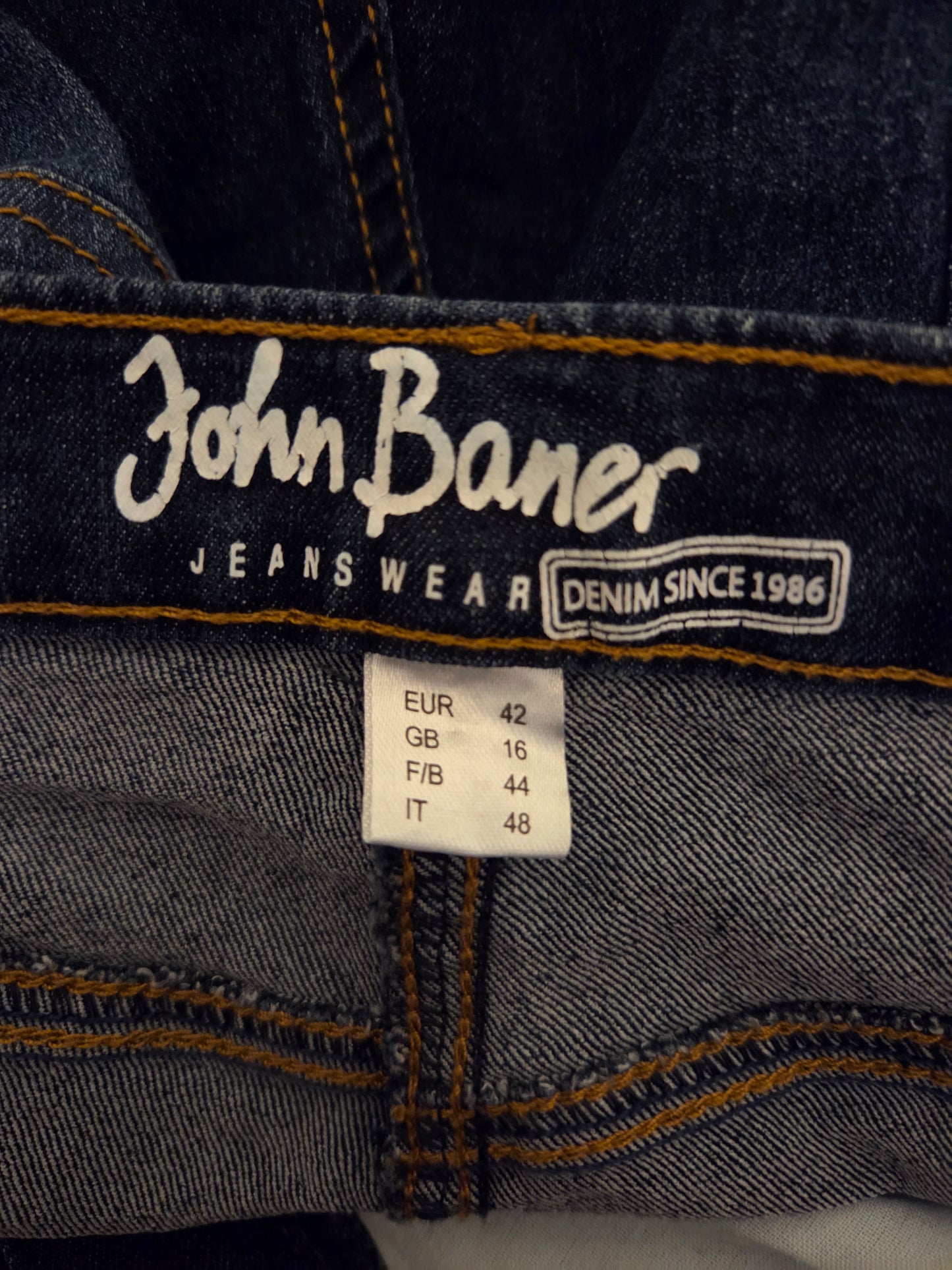Close-up of John Baner jeans with brand name and size label.