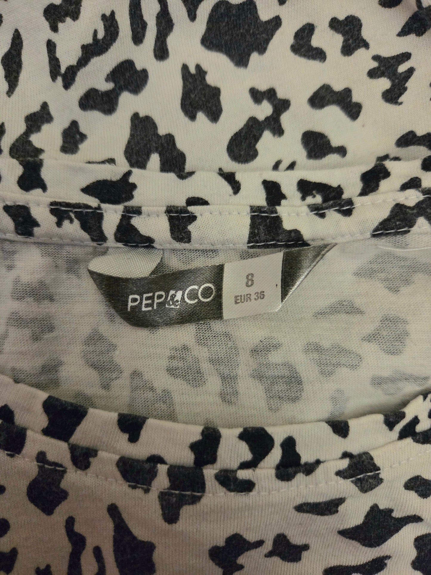 Clothing with a black and white pattern and a visible PEP&CO size label.