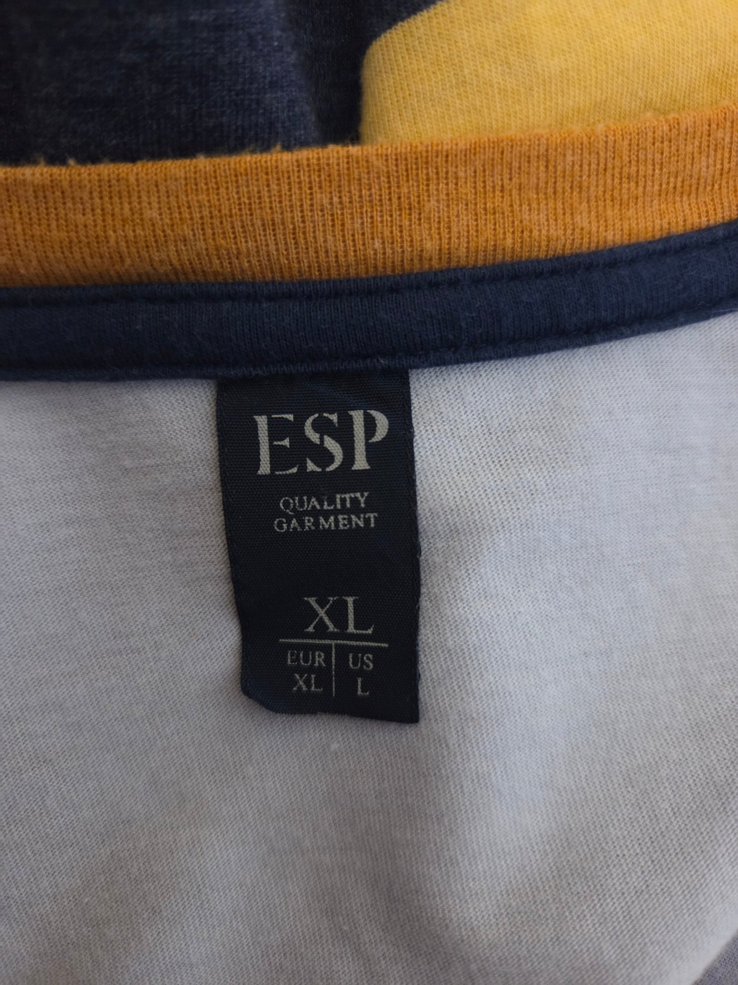 Close-up of an ESP label on a garment with a multicoloured background