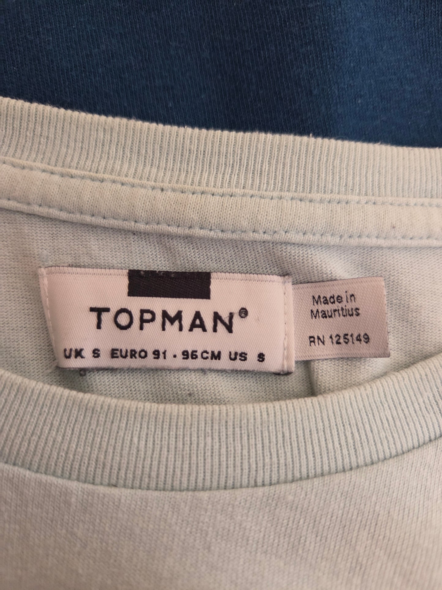 Topman label on a garment with a blue background