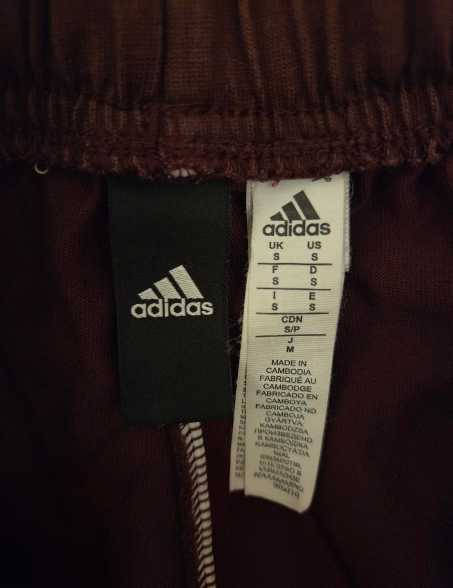 Size label showing the Adidas sign
