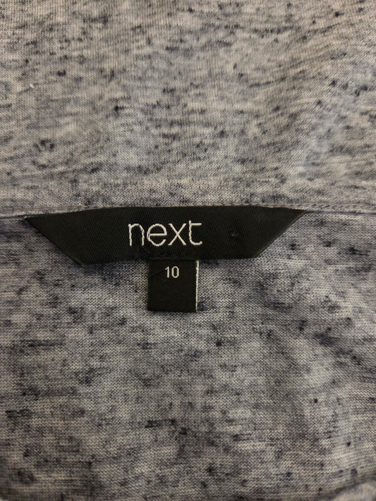 Close-up of a size tag with 'next'
