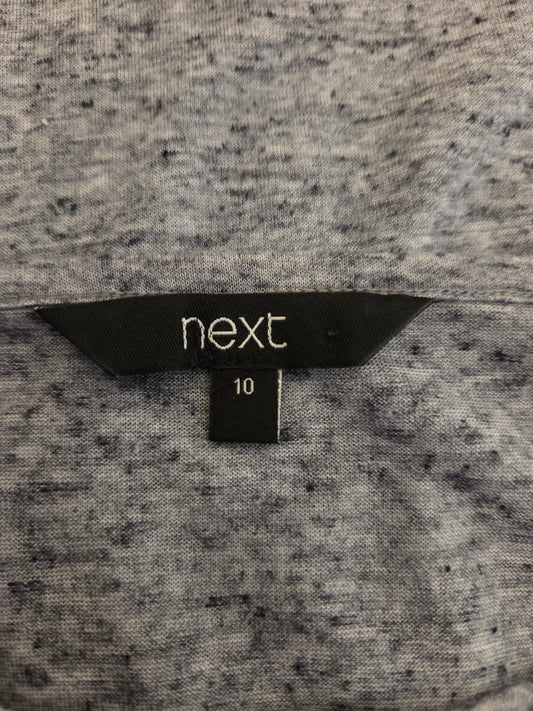 Close-up of a size tag with 'next'