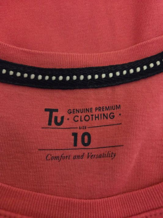 Close-up of a pink garment with 'TU Clothing' size label
