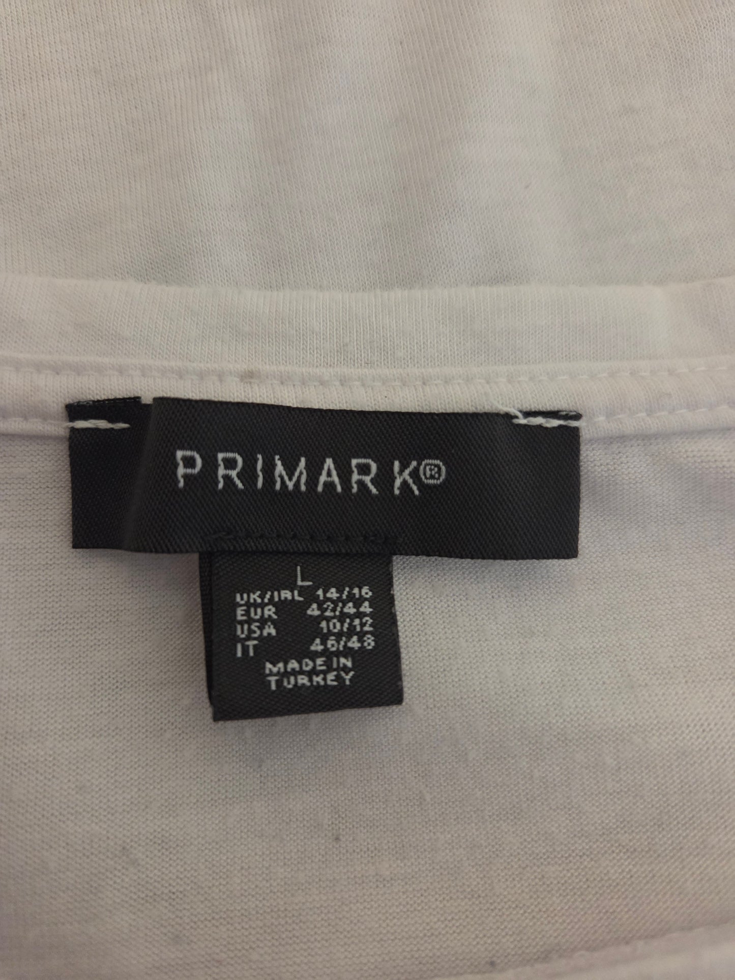 Primark label on a white shirt with size information