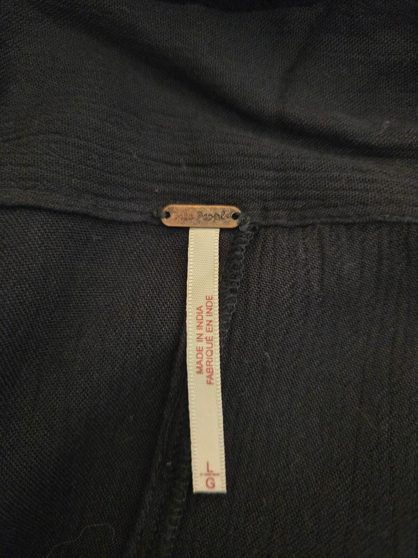Close-up of a black garment with a size label