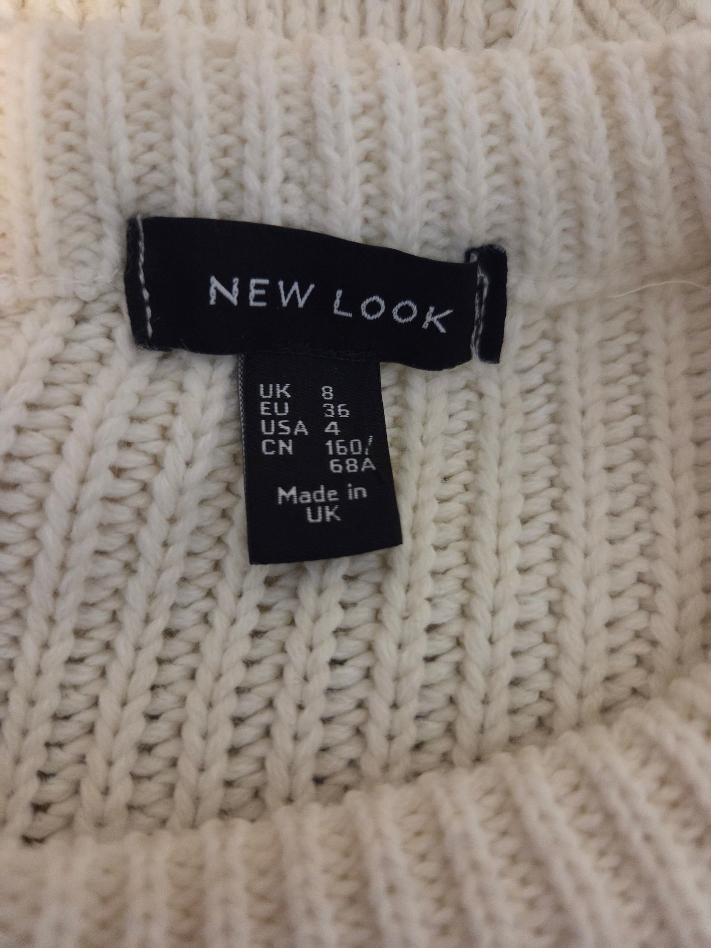 Close-up of a New Look label on a knitted fabric background