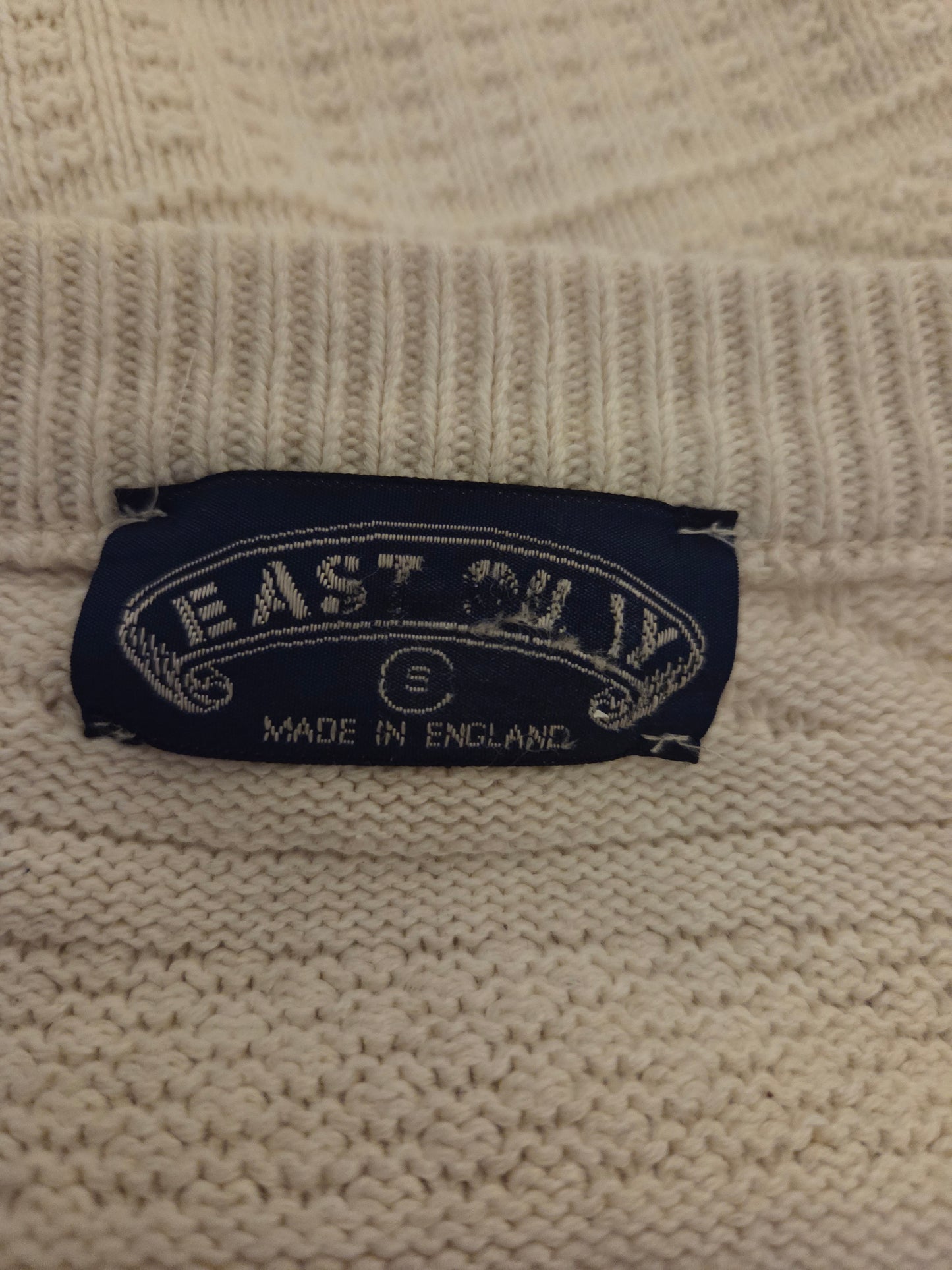 Size label on a beige jumper