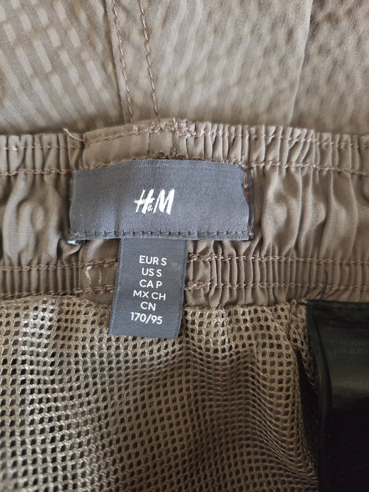 Close-up of a size label 'H&M' branding.