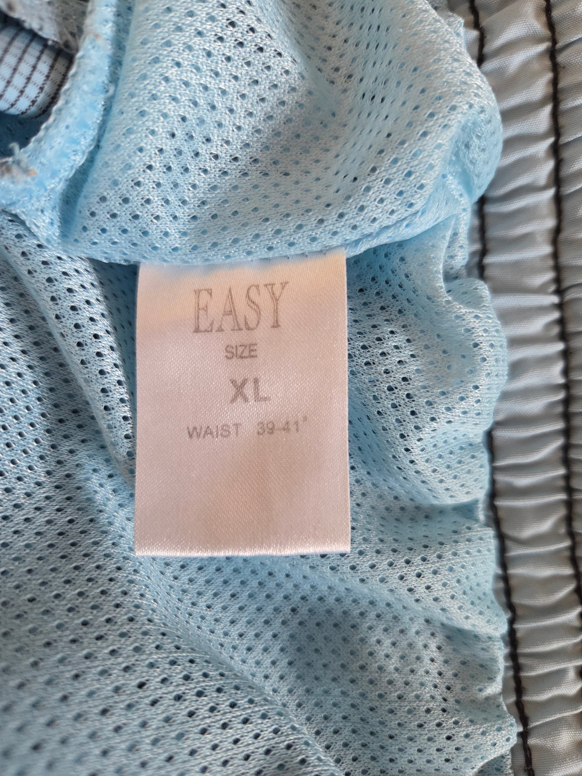 Light blue textured fabric with a size label on top