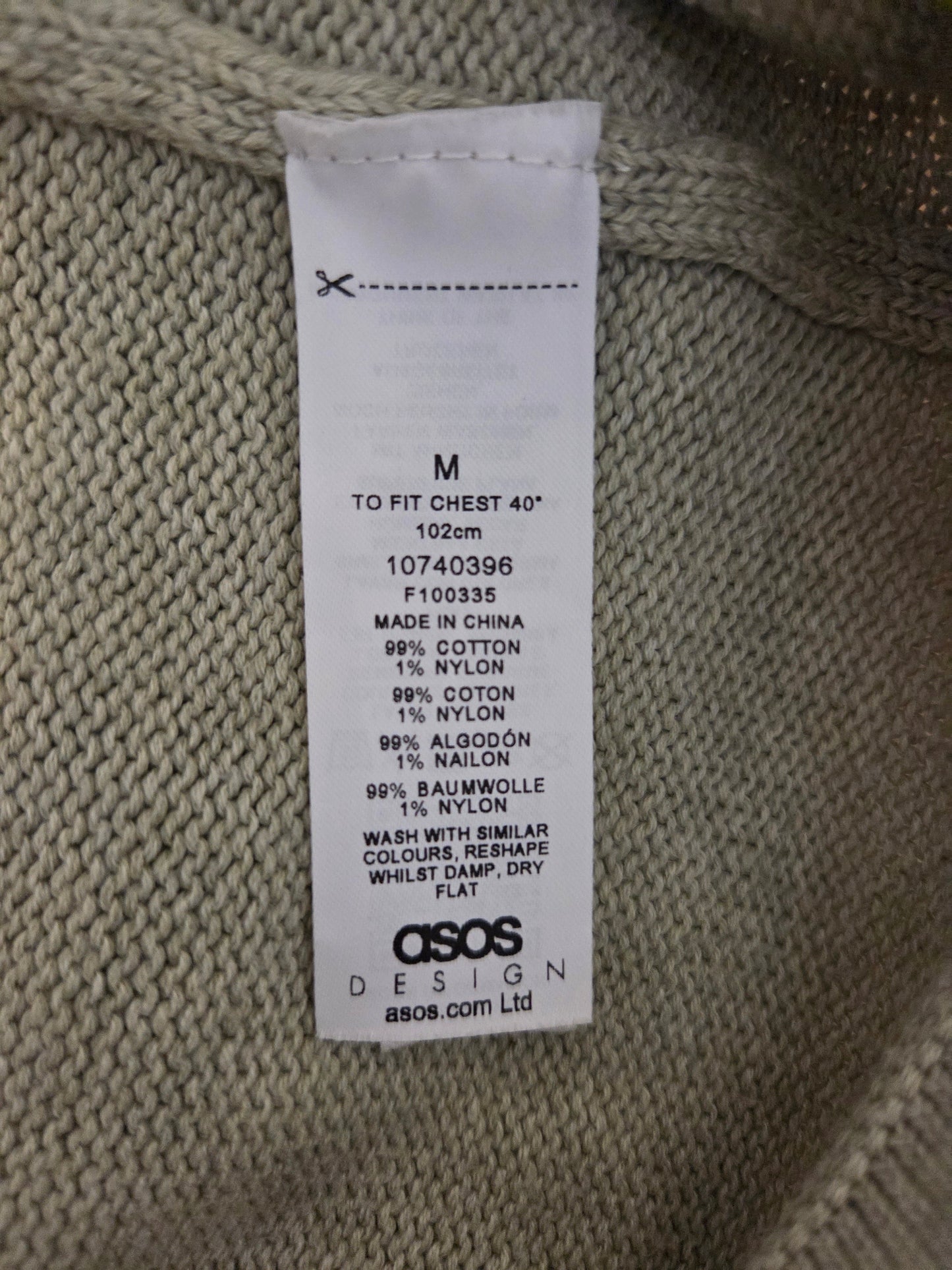 Size label on a knitted garment with ASOS branding