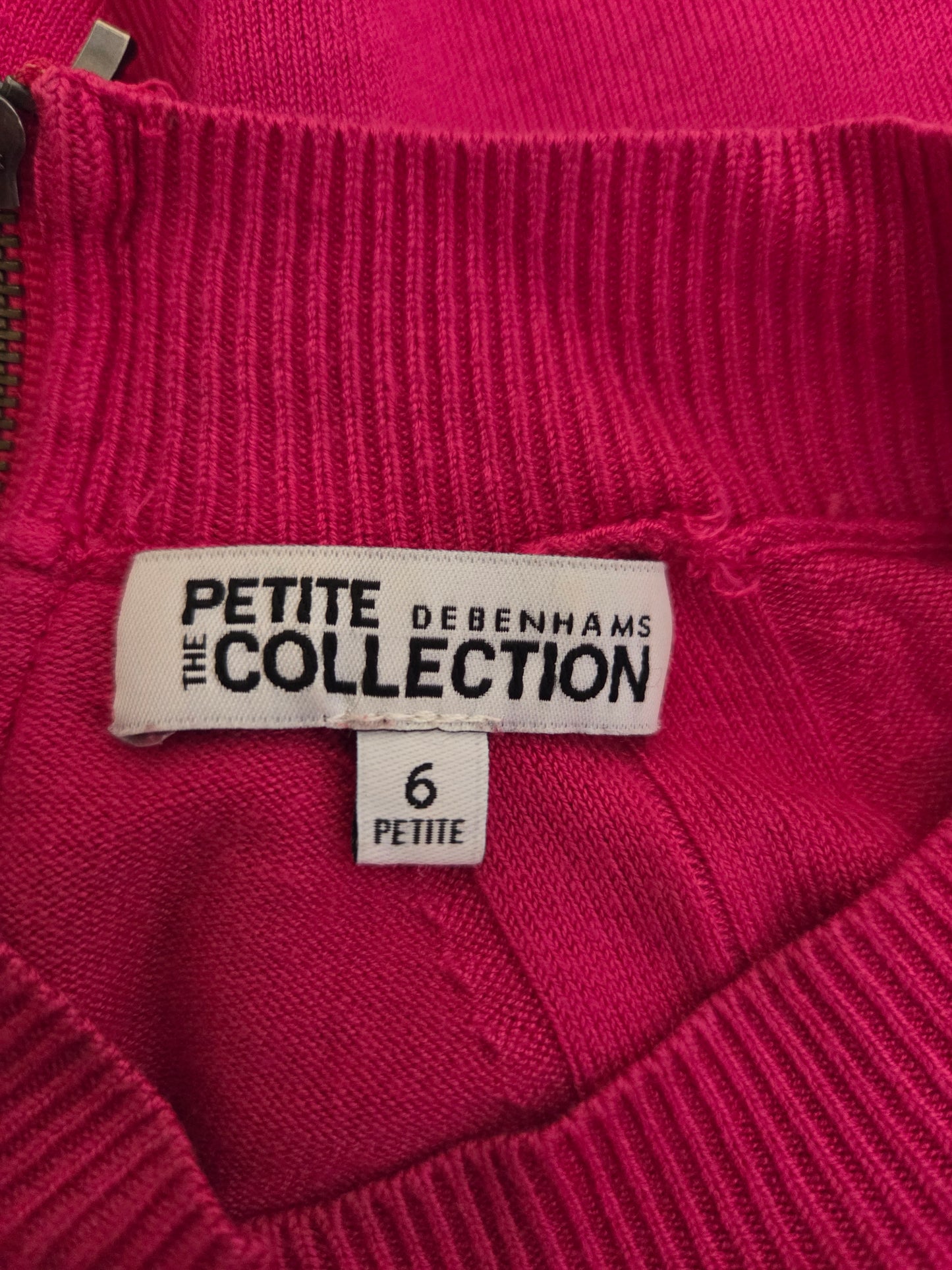 Close-up of a pink garment with a label reading 'Bodenham's Petite Collection'