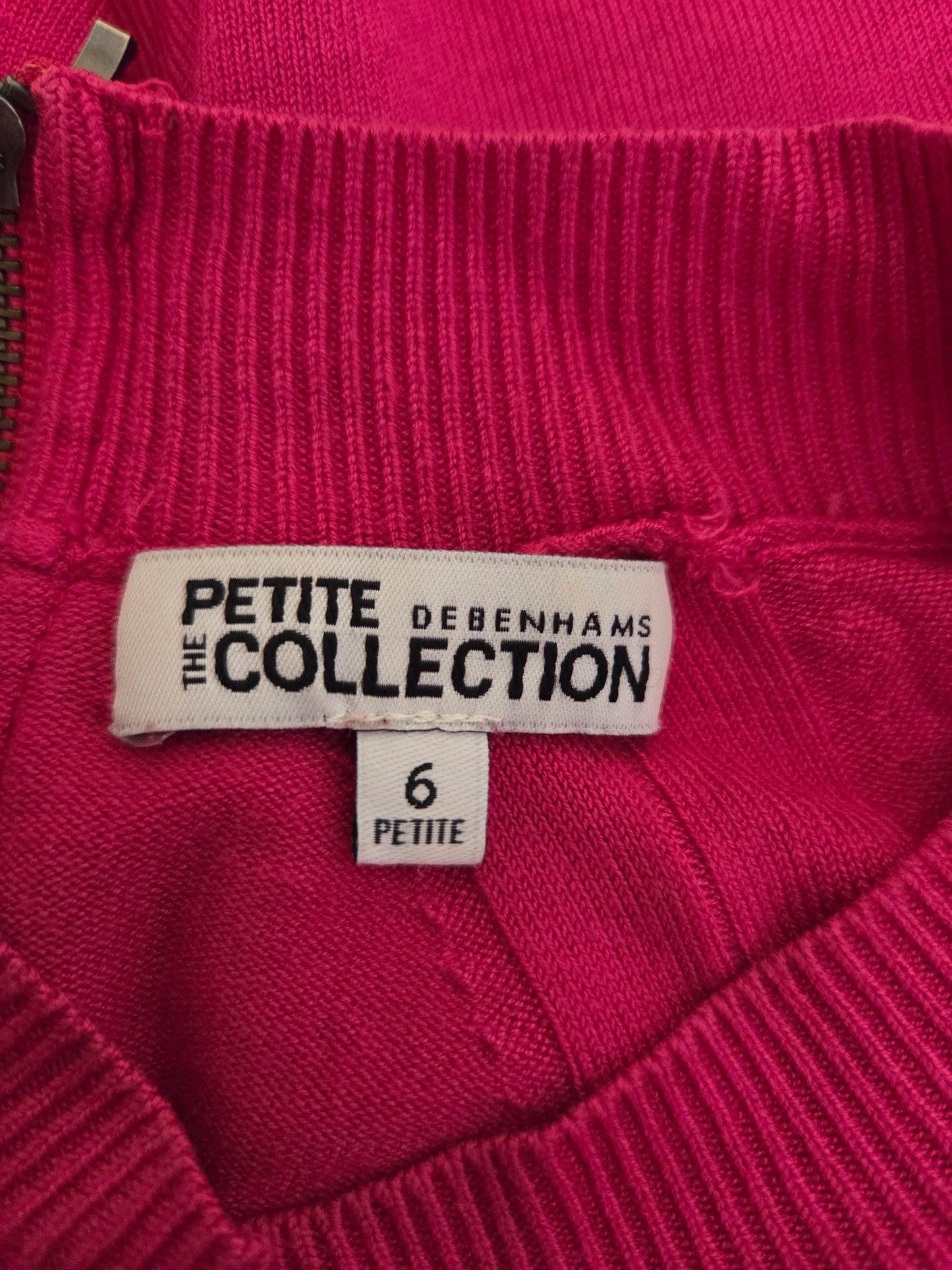 Close-up of a pink garment with a label reading 'Bodenham's Petite Collection'