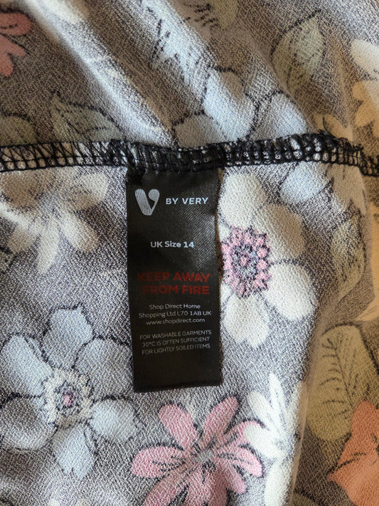 Clothing tag on a floral-patterned fabric
