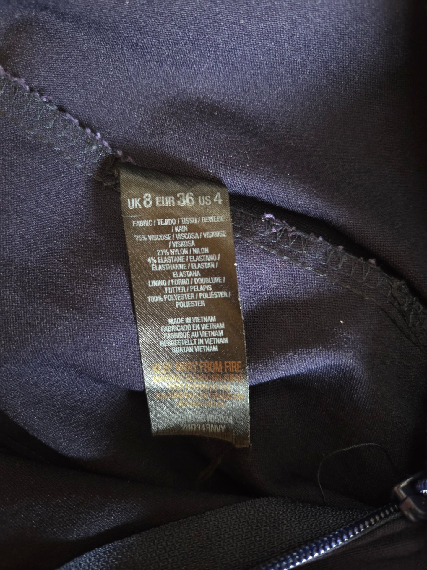 Clothing tag on a dark fabric background
