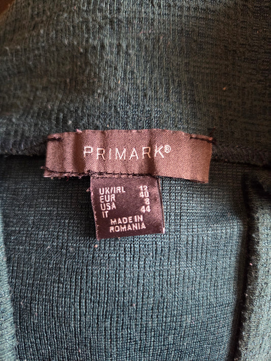 Close-up of a Primark label on a dark fabric background