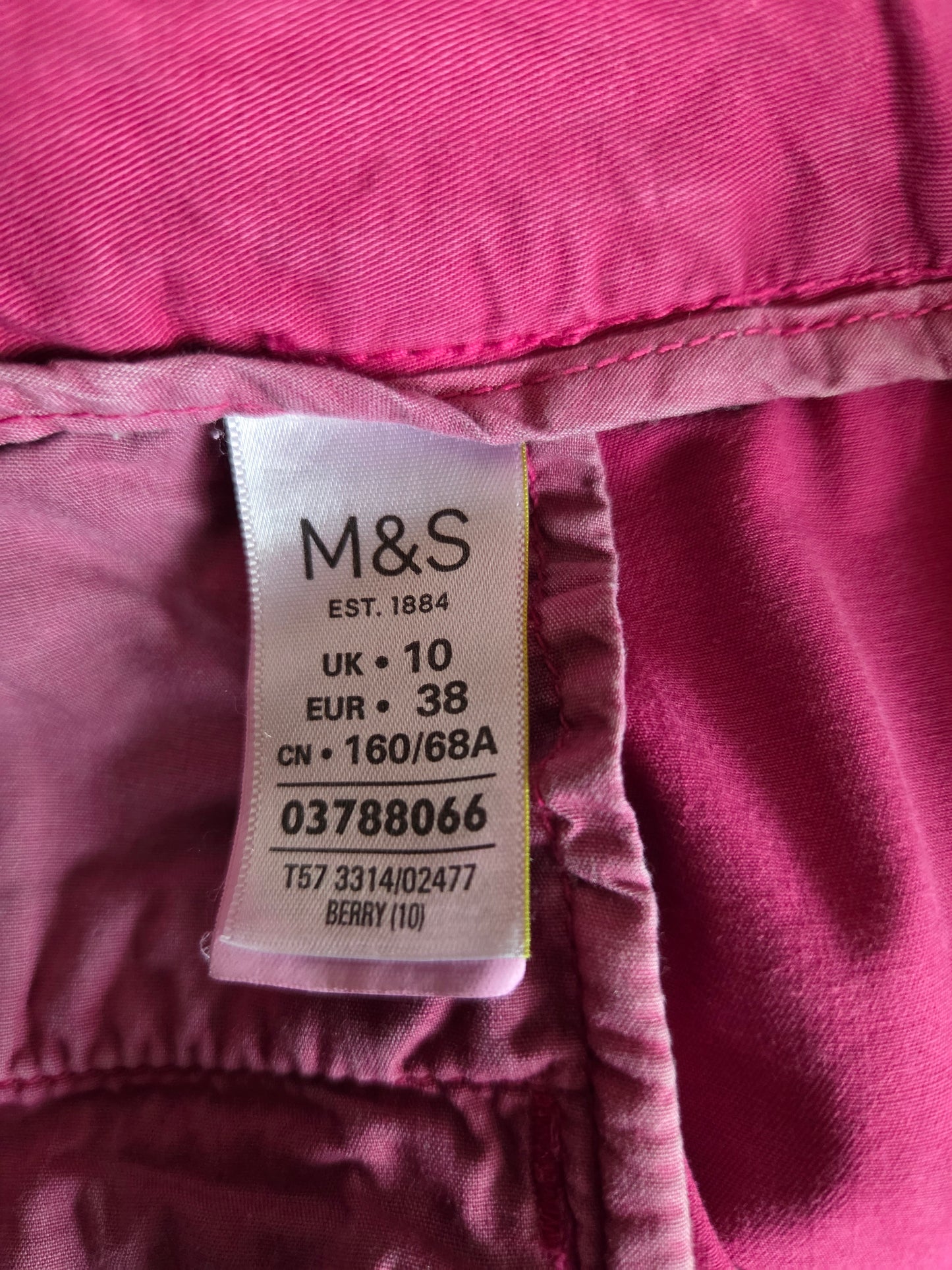 M&S size label on a pink material