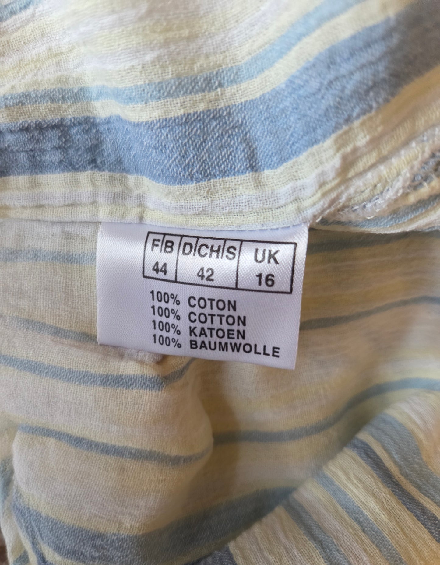 Fabric with a label indicating fabric details and size information.