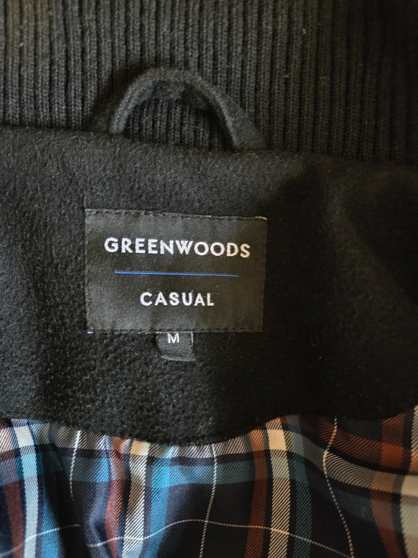 Label on a garment with 'Greenwoods Casual' branding