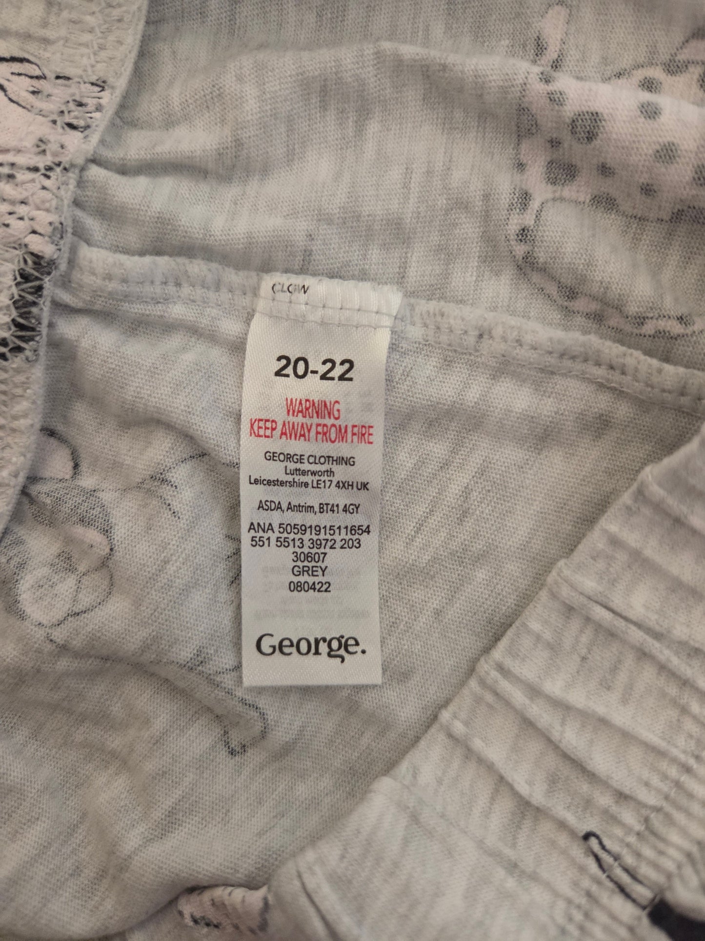 Clothing tag on a piece of fabric with 'George' branding