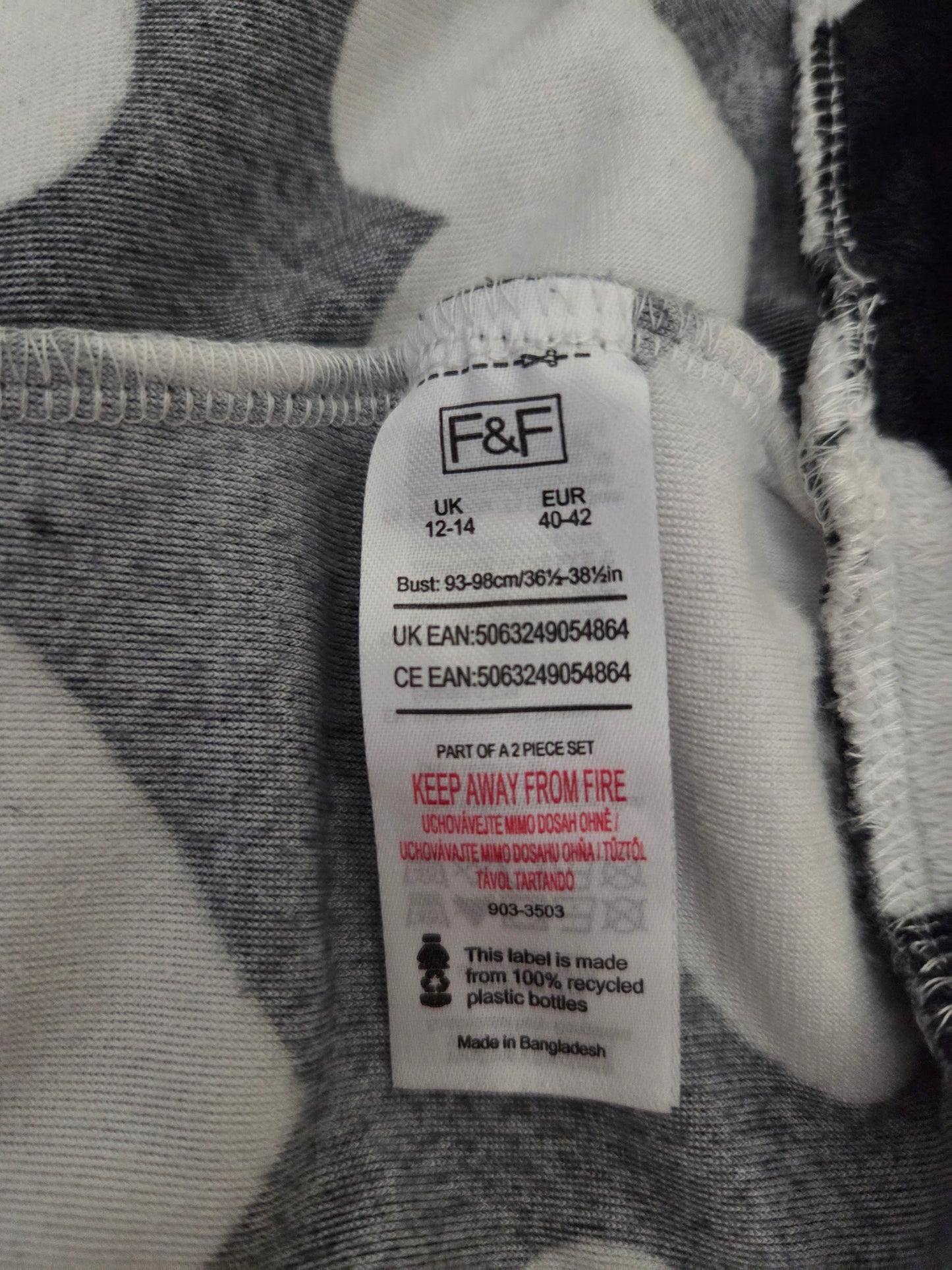 Close-up of a size label on a black and white fabric