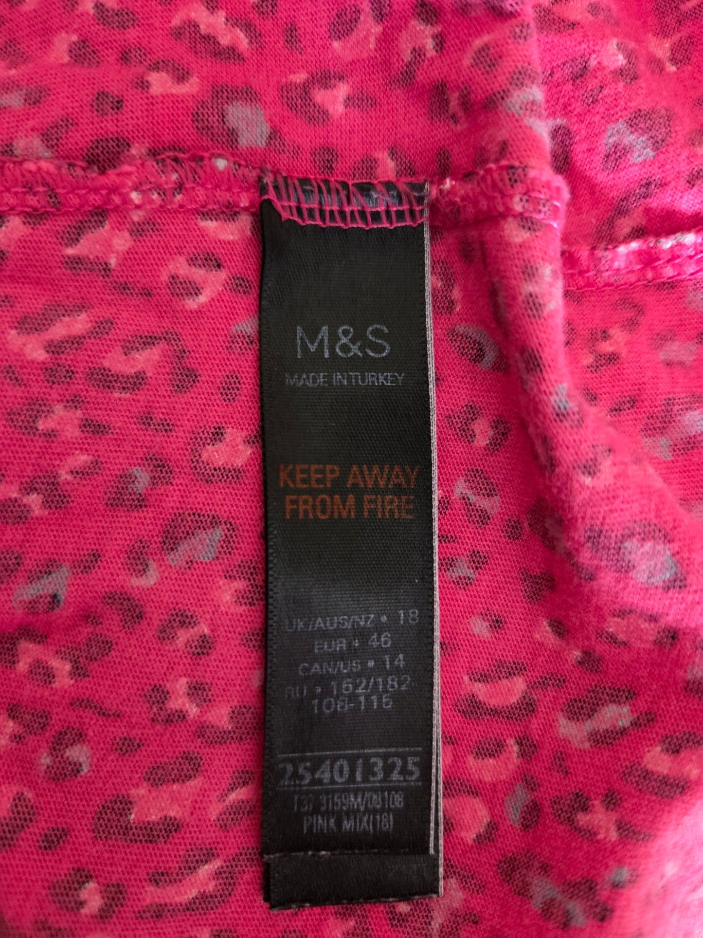 M&S size label on a pink fabric with black pattern