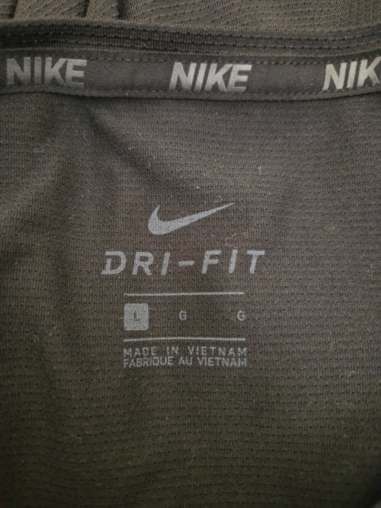 Close-up of Nike Dri-FIT label on a black athletic shirt.