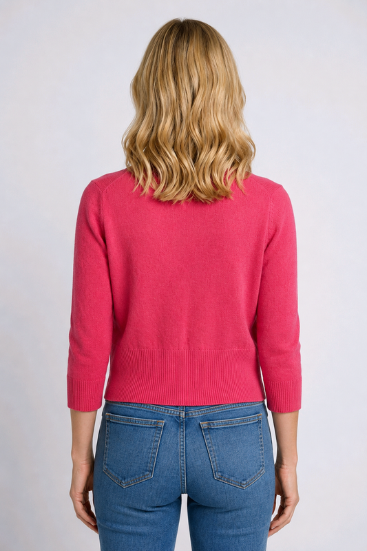 Woman wearing a pink cardigan back view