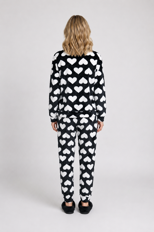 Woman wearing a black and white heart-patterned pajama