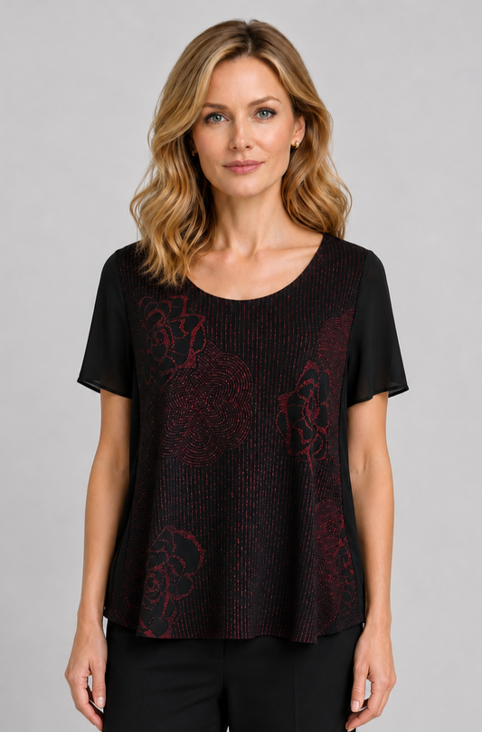 Woman wearing a black & red top with patterns