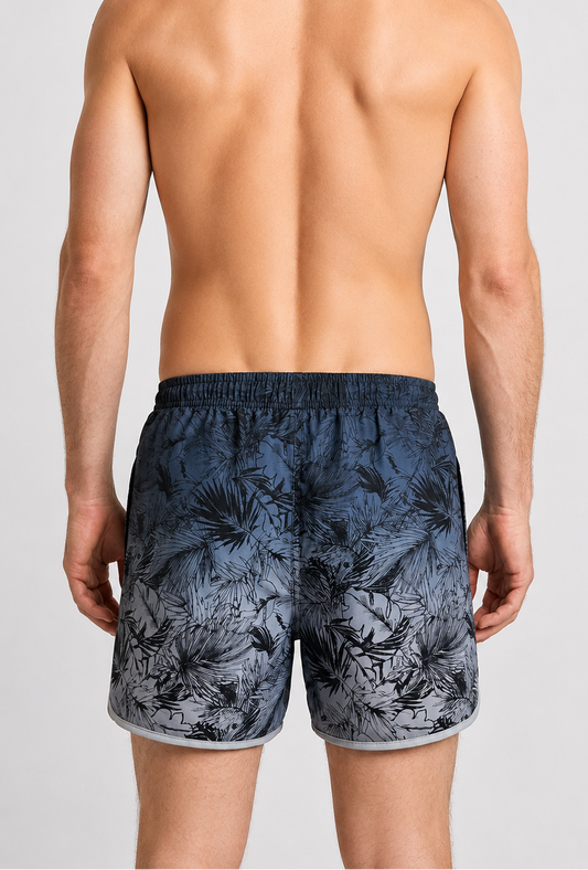 Person wearing navy floral swim shorts