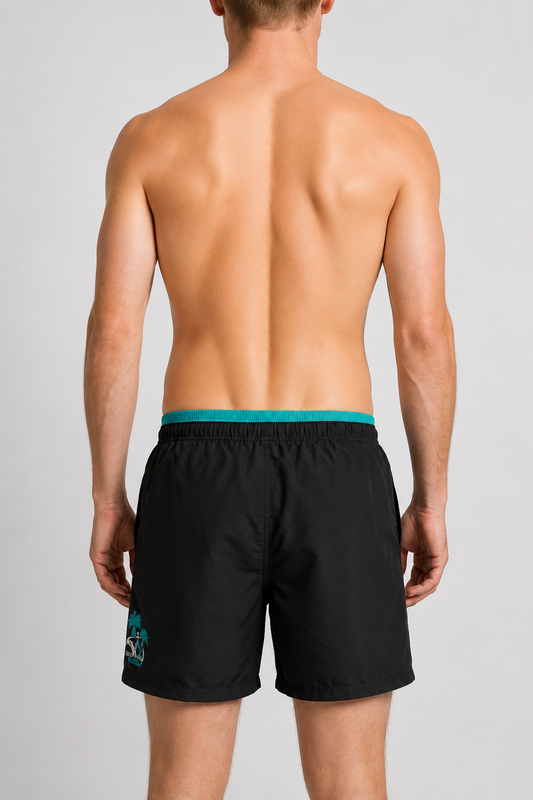 Man wearing black swim shorts with a green waistband