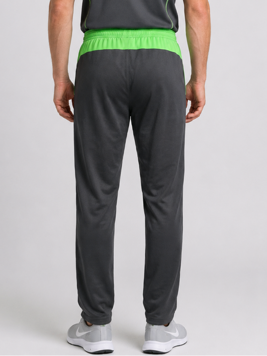 Man wearing grey Nike Tracksuit bottoms with green waistband