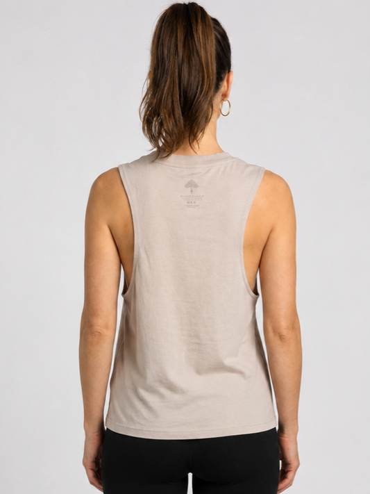 Woman wearing a beige sleeveless top back view