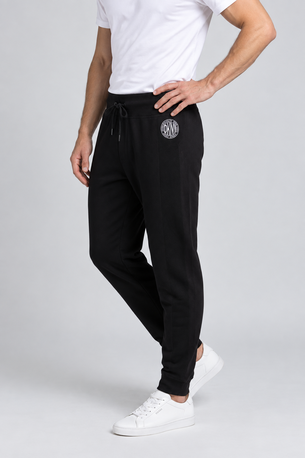 Close up of a man wearing a pair of black DKNY joggers size M side view
